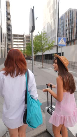 two women walking on city street