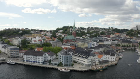 Hotel-Clarion-En-Tyholmen-Y-La-Iglesia-De-La-Trinidad-Al-Fondo-En-Arendal,-Noruega