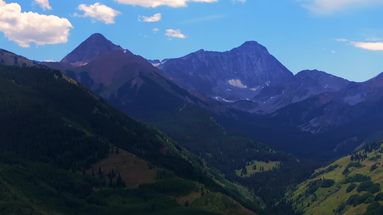 Capitol Peak Aspen Snowmass Wilderness spring summer aerial drone parallax Colorado Elk Range Rocky Mountains 14er Capitol Creek Trailhead Aspen grove White River National Forest valley circle right