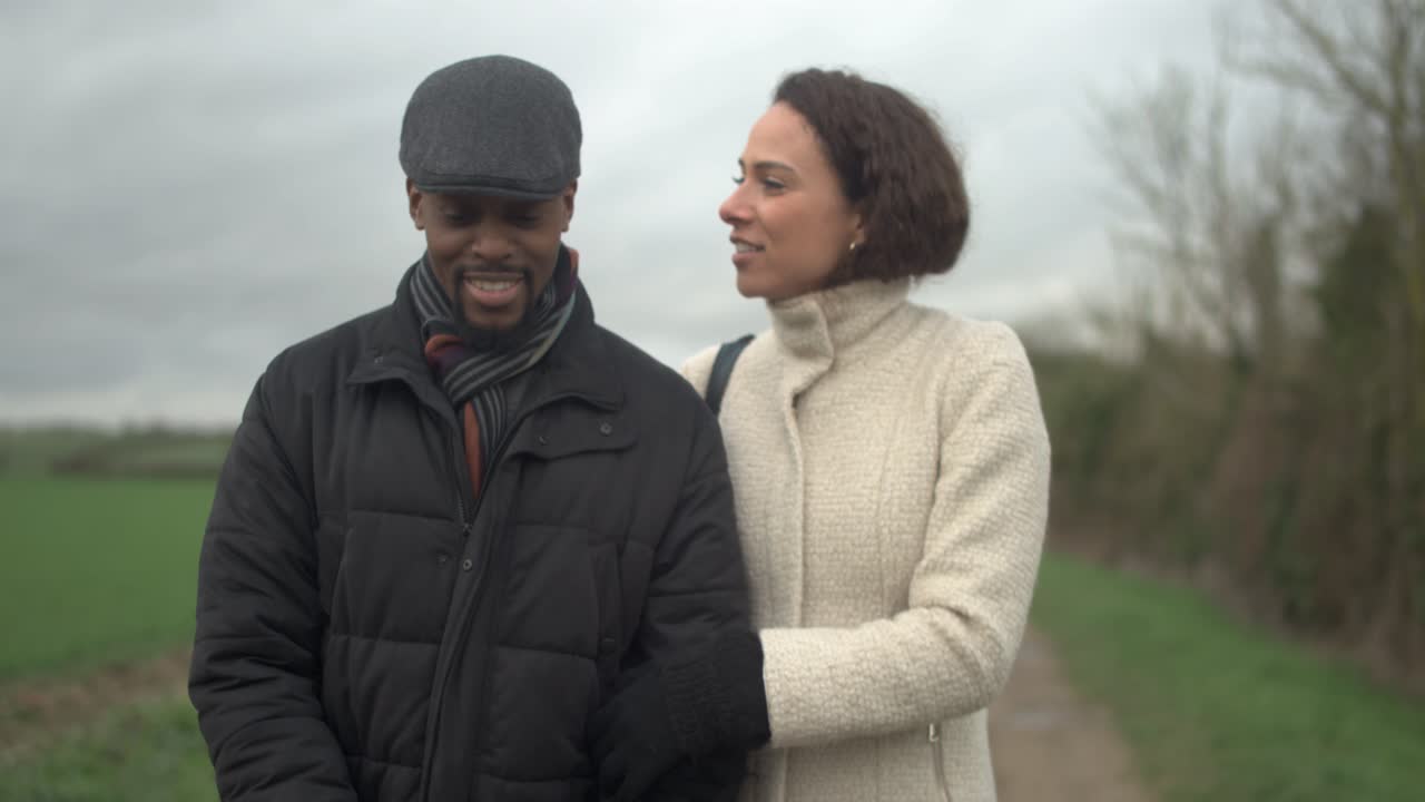 Man and Woman Walking Through Countryside