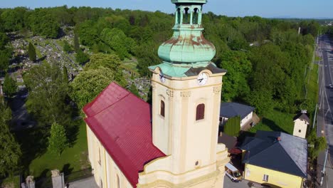 church with cemetery in the background in ostraca, czech republic during the summer with clear skies and mountains in the background