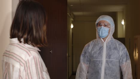 doctor with vaccine ampoule visiting woman patient at home offering vaccination against coronavirus