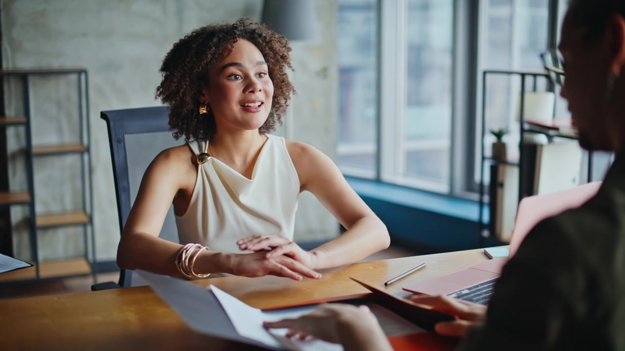 Businesswoman reviewing documents client meeting, woman explaining contract