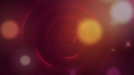 Digitally-generated-video-of-glowing-spots-moving-over-circles-against-red-background