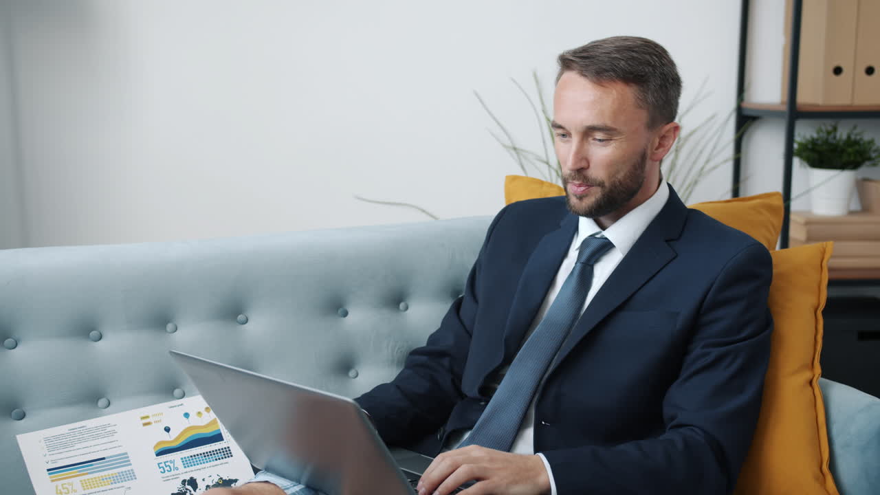Businessman reviewing data on laptop at home