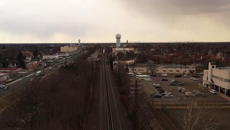 an aerial view over railroad tracks on a cloudy day