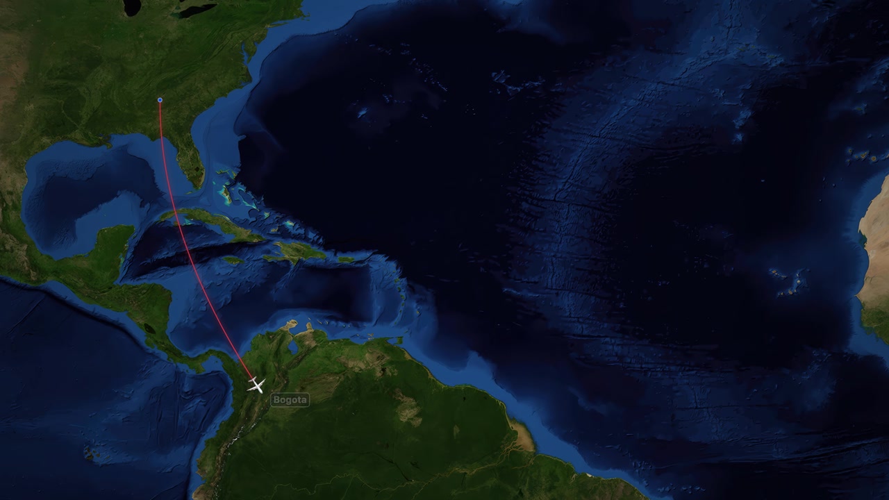 A digital animation tracks a plane flying from Atlanta to Bogota across a satellite map
