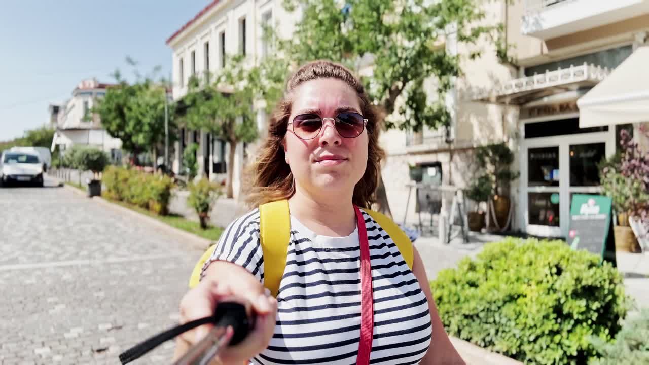 Woman Preparing Her Selfie Stick for Filming, Athens, Greece