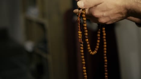 tibetan monk praying with the mantra wheel