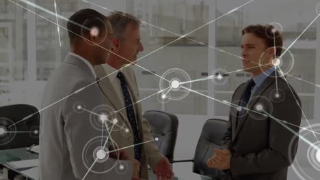 animation of network of connections with icons over diverse business people in office