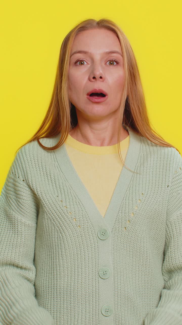 Amazed shocked excited mature woman touching head and showing head explosion looking worried shocked