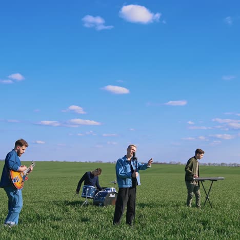 musical band playing on grass. group of young people playing instruments on field