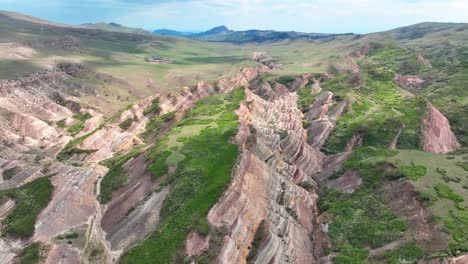 aerial view over colorful rainbow valley in georgia - drone shot