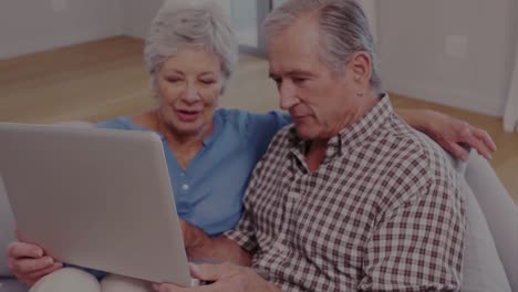 animation of senior caucasian couple using laptop