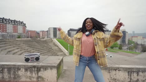 Cheerful-woman-listening-to-music-and-dancing-freestyle