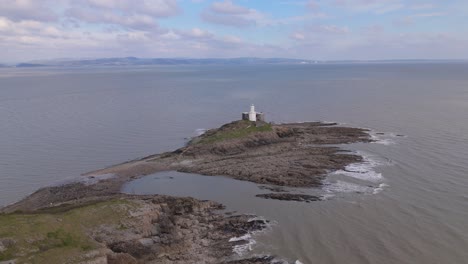 aerial view of mumbles lighthouse during daytime in united kingdom, drone shot