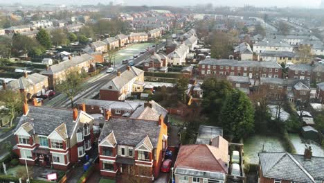 Aerial-view-frosty-white-winter-residential-town-neighbourhood-rooftops-dolly-left