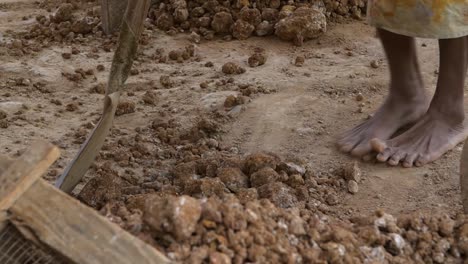 feet kicking and moving rubble