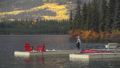 lonely female with camera walking on docks at pyramid lake and island