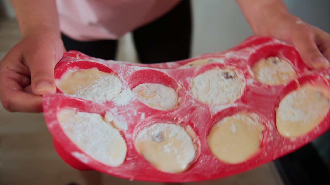 A Step-by-Step Baking Journey: Preparing and Baking Delicious Muffins in a Home Kitchen with Hands in Action and Dough in the Oven