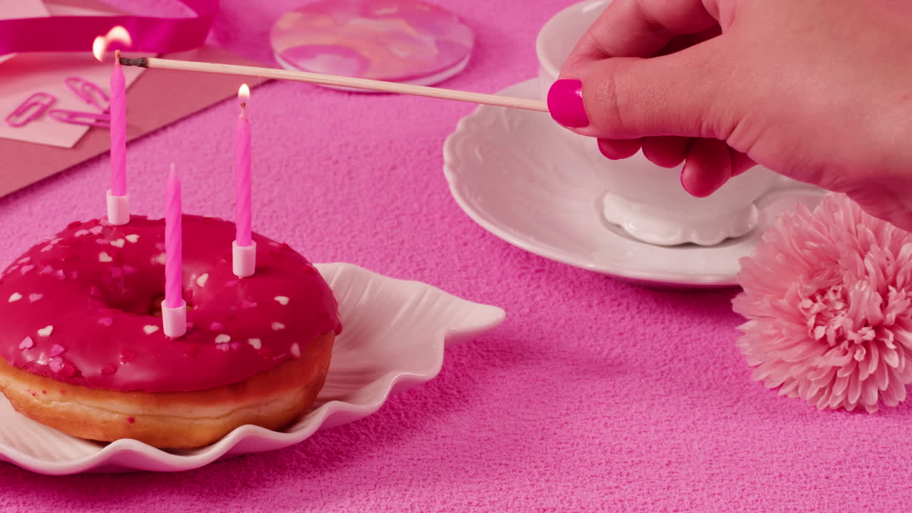 Celebrating a Birthday with a Pink Donut