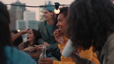 group of young friends enjoying rooftop party celebration drinking alcohol having fun chatting sharing friendship students making toast to summer vacation