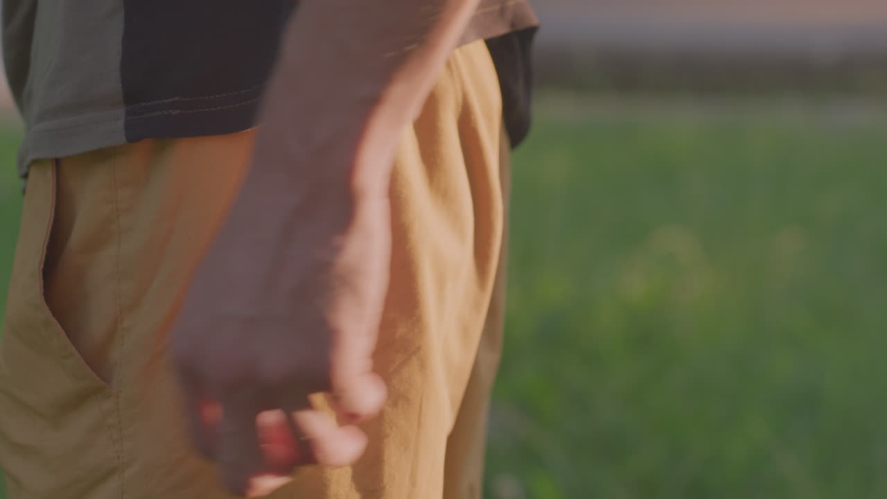 Relaxed Person Enjoys Tranquil Sunset Evening, Person Peacefully Strolls Under Soft Glow Of Sunset Sky, Individual Leisurely Walks Through Nature During Calm And Serene Sunset Evening
