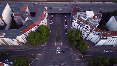 aerial view of a city with roads, highway, and train tracks