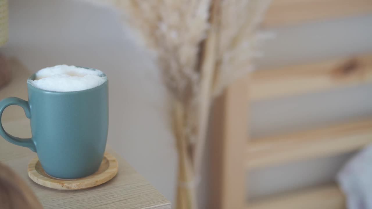 A cup of cappuccino on a wooden table