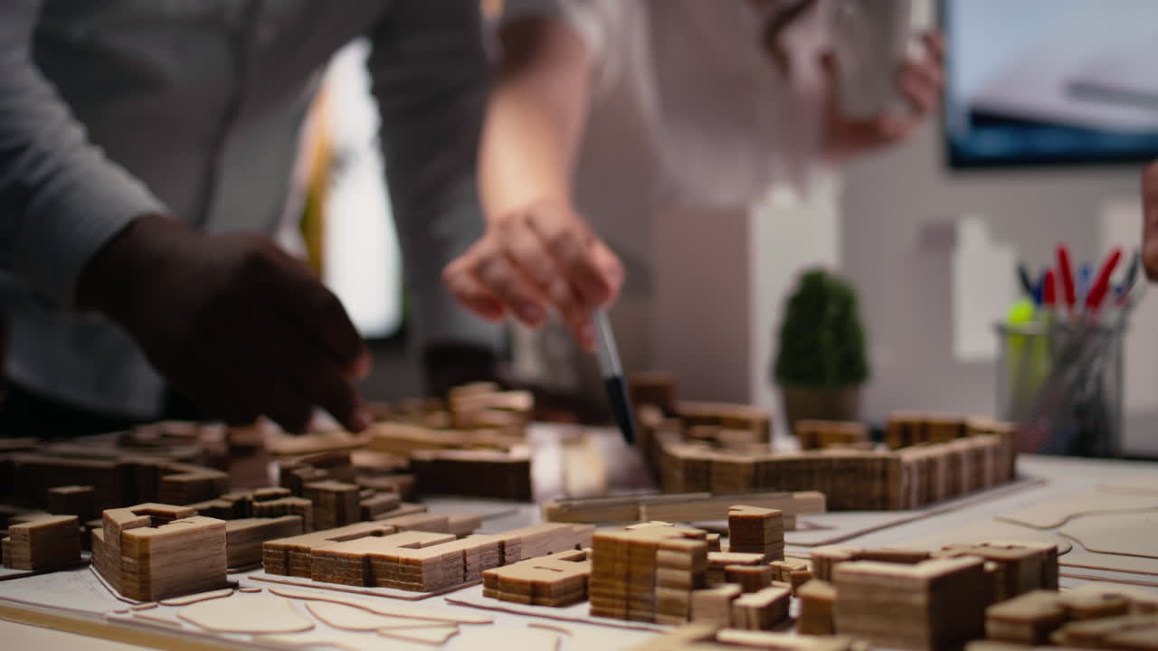 Close up of contractors arranging housing layout for urban site preparation