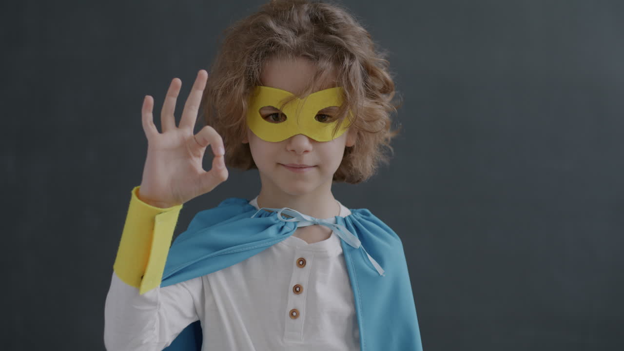 Young Superhero Child Making an Ok Sign