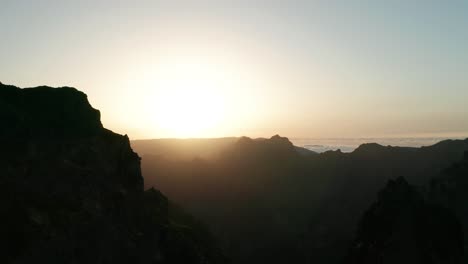 truck right aerial of spectacular mountain range during bright golden sunset