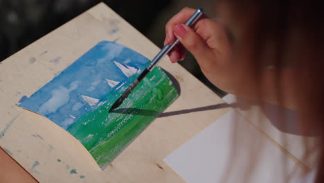 woman painting a watercolor seascape