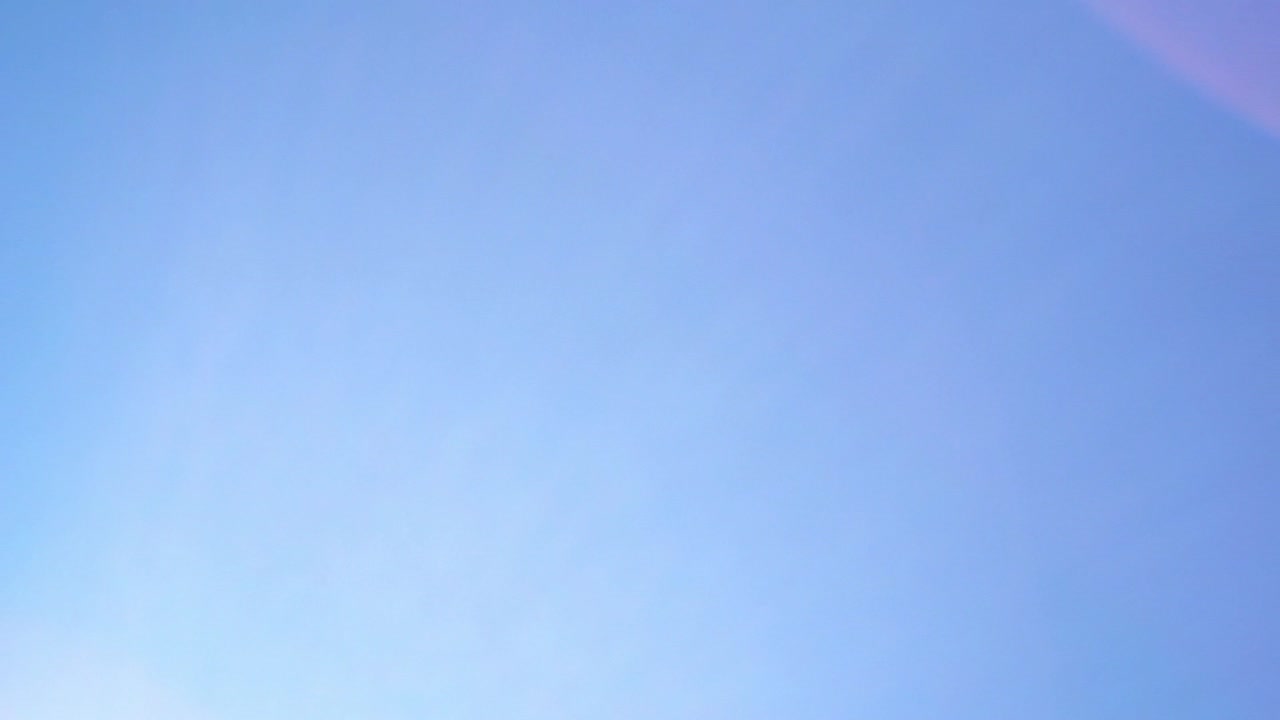 Lens flare on clear sunny day with no clouds and bright blue sky