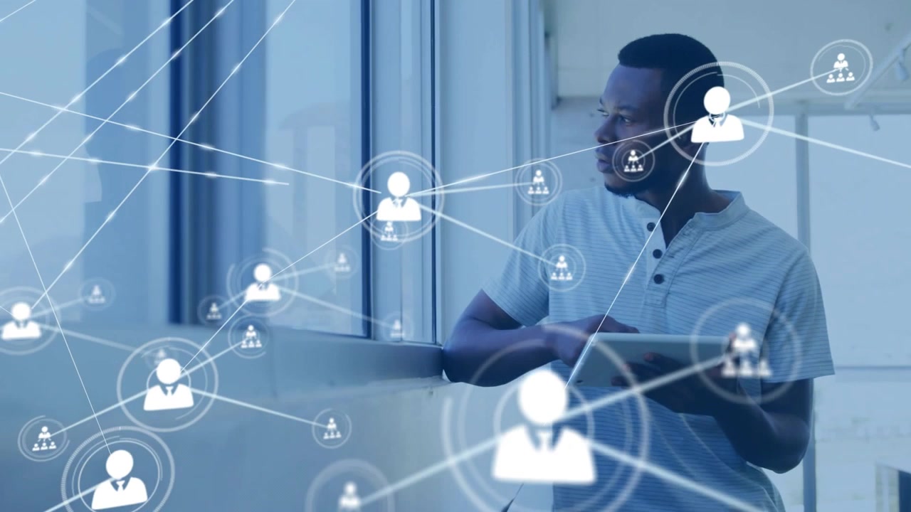 Man holding tablet by window tracking appearing user icons and connecting lines for tech analysis