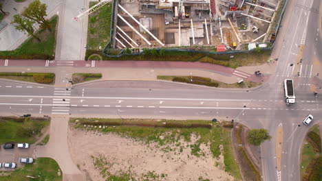 Aerial-top-down-shot-showing-center-of-Gdansk-city-with-construction-site-at-sunny-day---truck-leaving