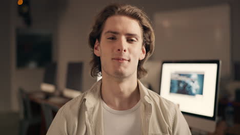 young man talking to camera in office