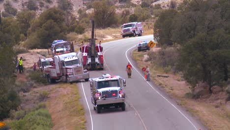 the aftermath of an accident on a rural highway features police fire and emergency vehicles