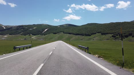 moving view (car, motorbike or bicycle) of a mountain landscape