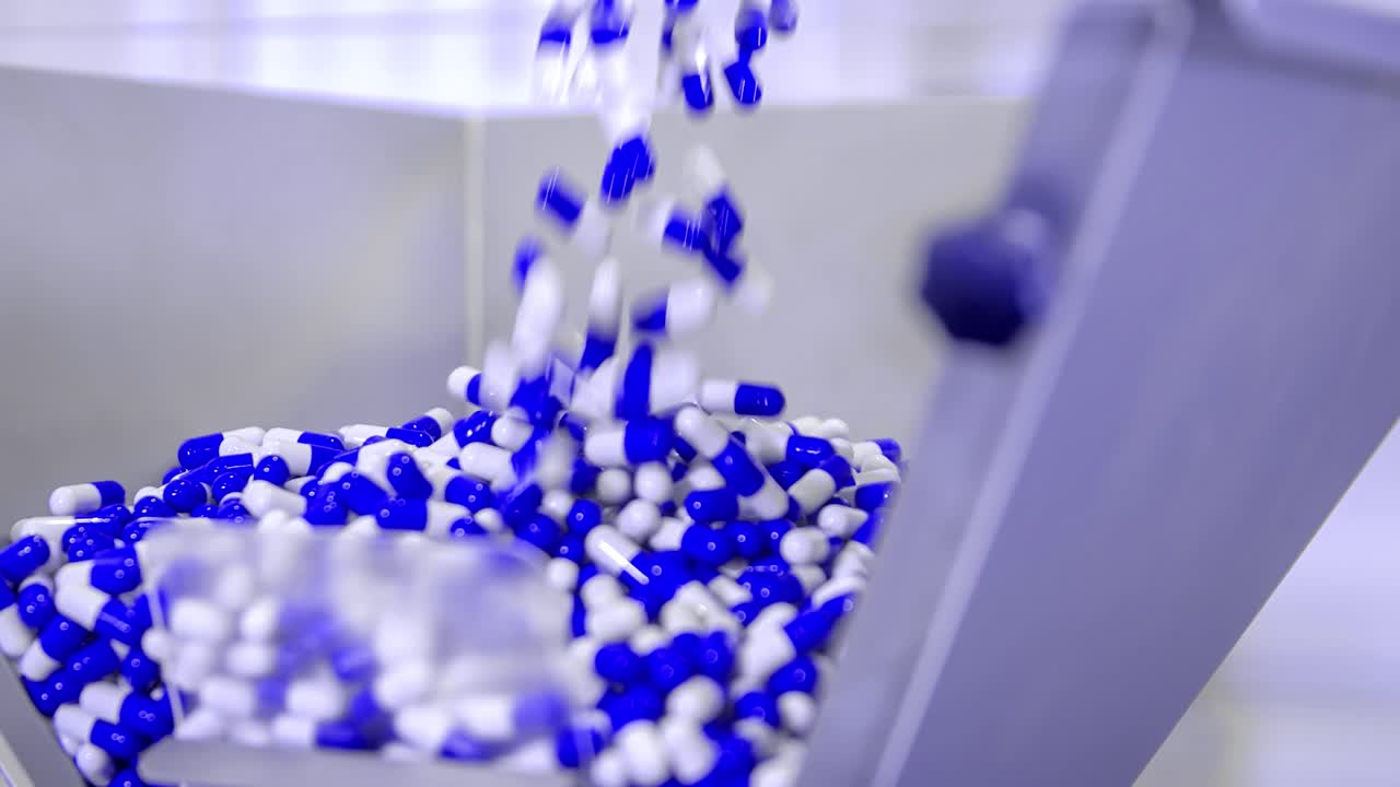 Close up from coronavirus medicine. blue and white pills thrown into a dispenser. Covid19 pandemic