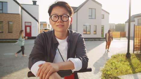 portrait of young asian woman with e-scooter on street