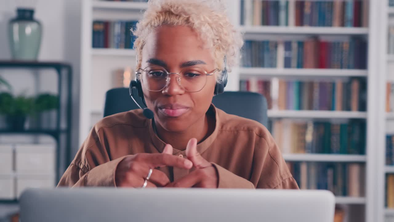Smiling woman in headset waving hand hello gesture starting online meeting