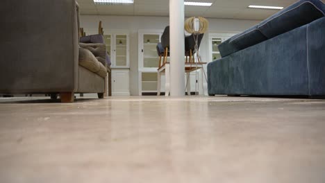 cleaning dirty floor with a power steamer in furniture store