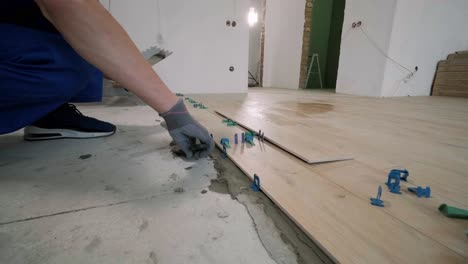 installing ceramic floor tiles - measuring and cutting the pieces. construction, renovation, repair apartment. cuts tile. tile cutting