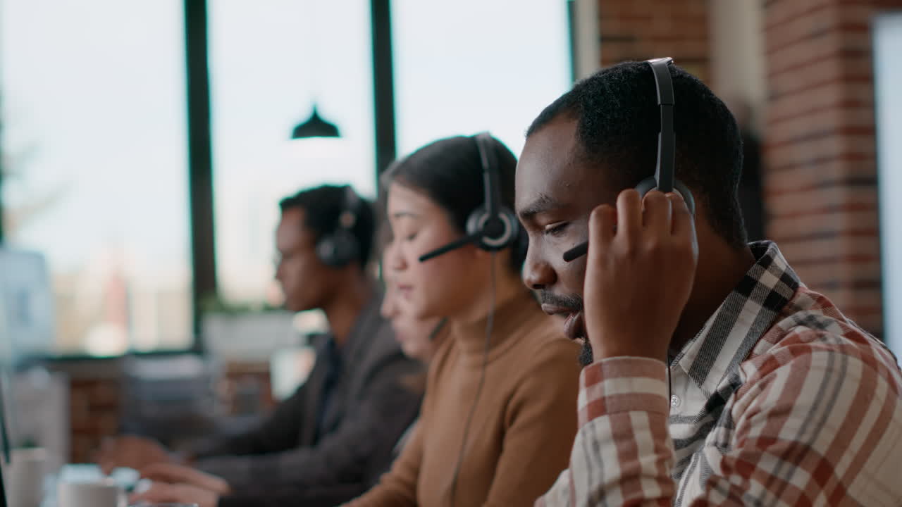 Male worker answering telework phone at call center