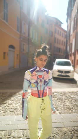 stylish young woman in colorful urban outfit