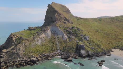 aerial tracking shot of coastal castle rock near castlepoint in new zealand