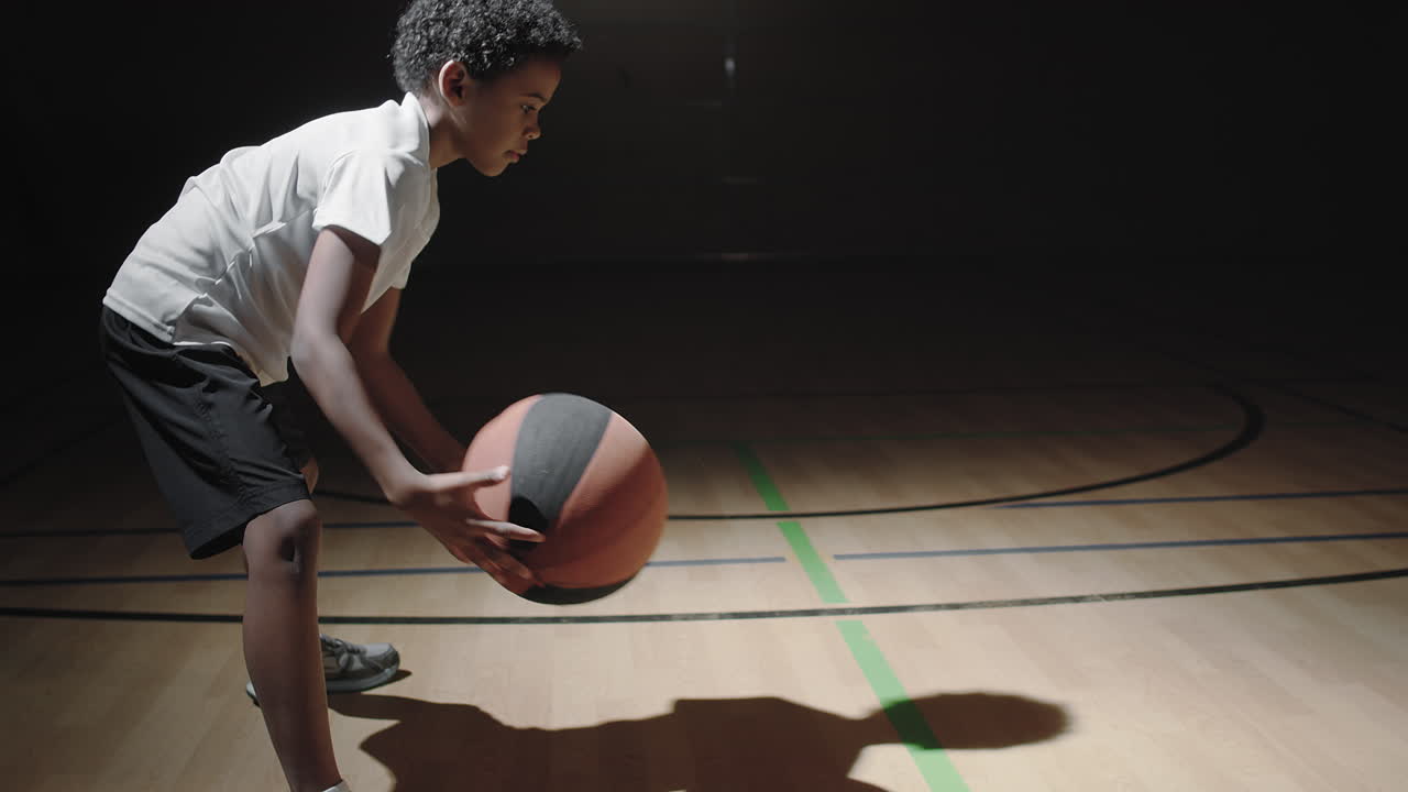 Boy Practicing Dribbling Basketball