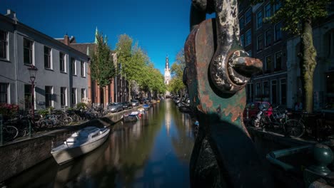 timelapse video of a canal in amsterdam, during fall - autumn. in the distance, the zuiderkerk or 'south church' can be seen.