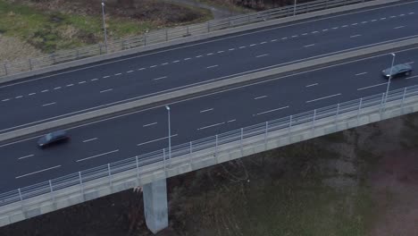 mersey gateway toll bridge highway traffic driving across river estuary aerial birdseye view tilt up right